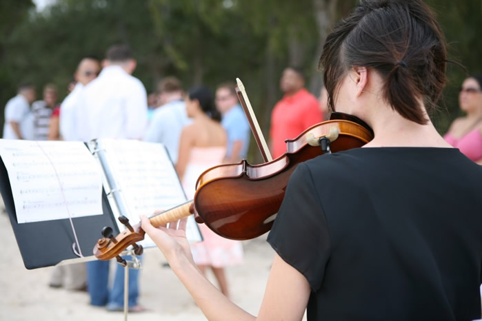 violinist playing at a wedding in Hawaii reading her music